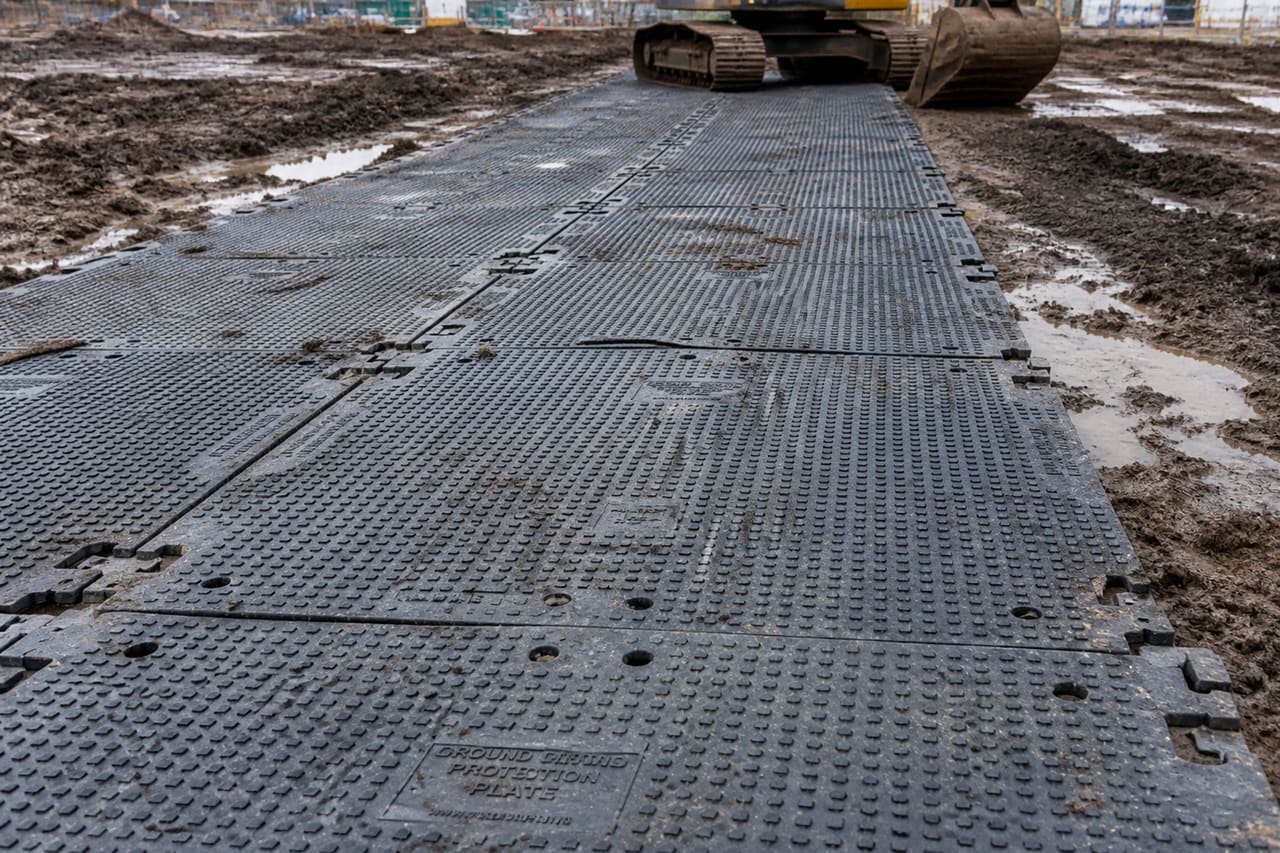 Heavy Duty Plastic Track Mats on Muddy Construction Site