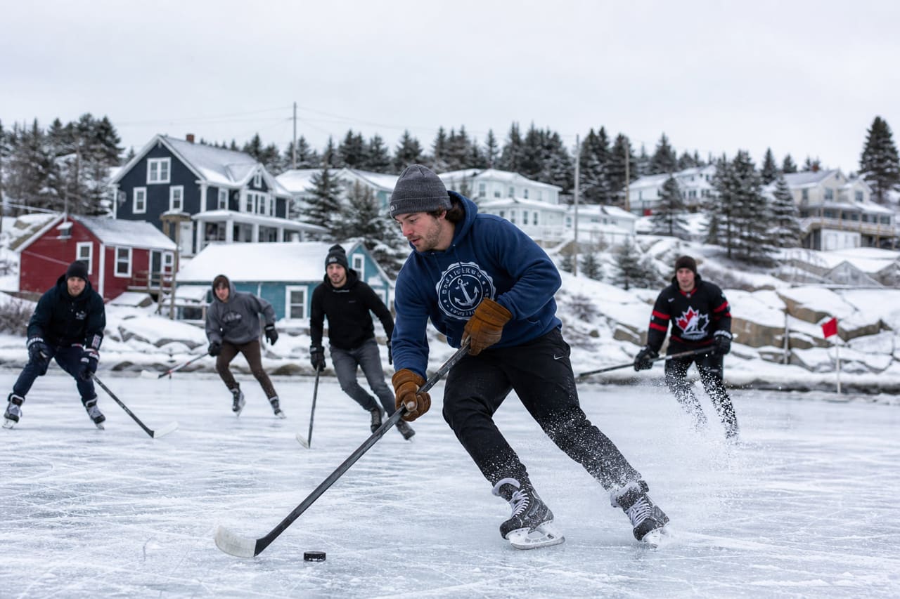Young Adults Playing Pond Hockey in a Nova Scotia Village