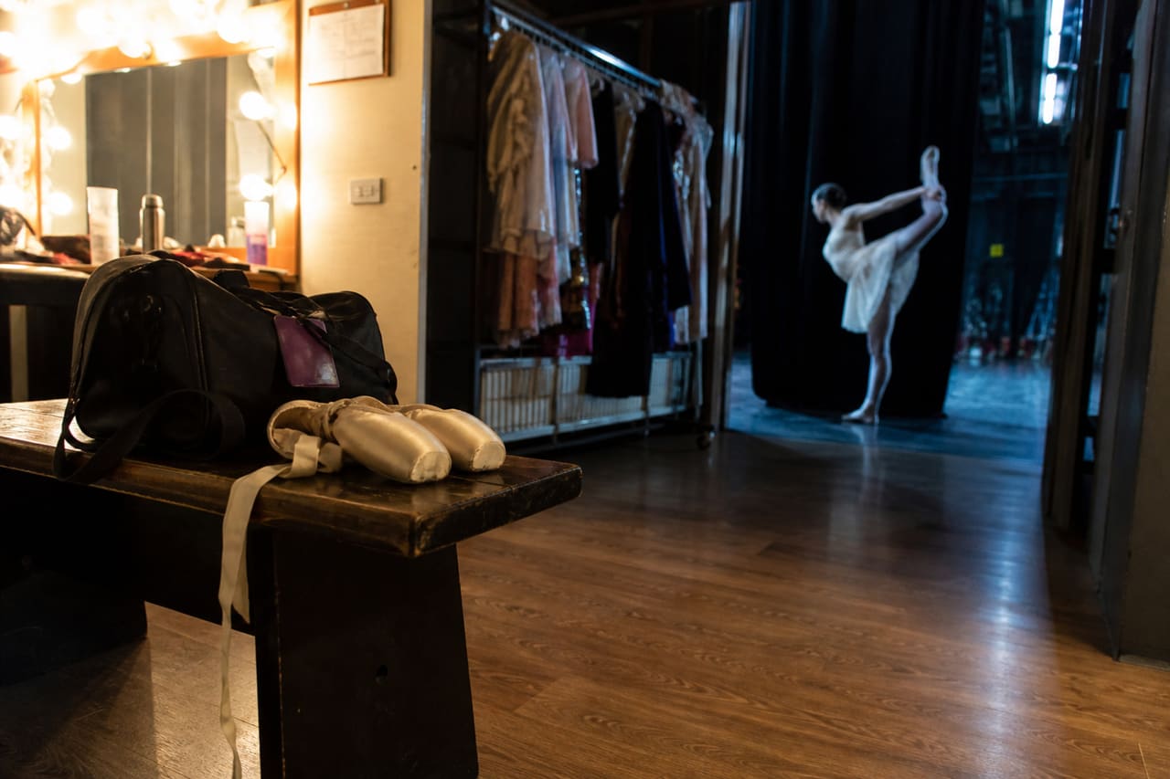 Dancer Preparing in a Backstage Dance Studio