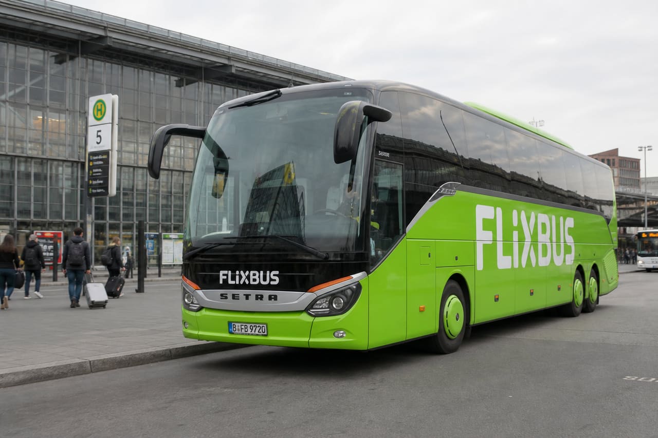 Green Intercity Bus Parked at a Modern European Terminal