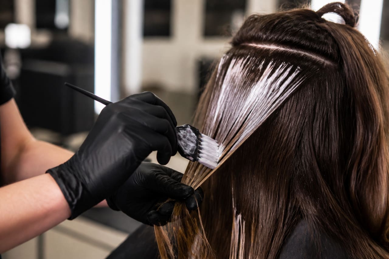 Professional Stylist Applying Bleach for Balayage Technique in Salon