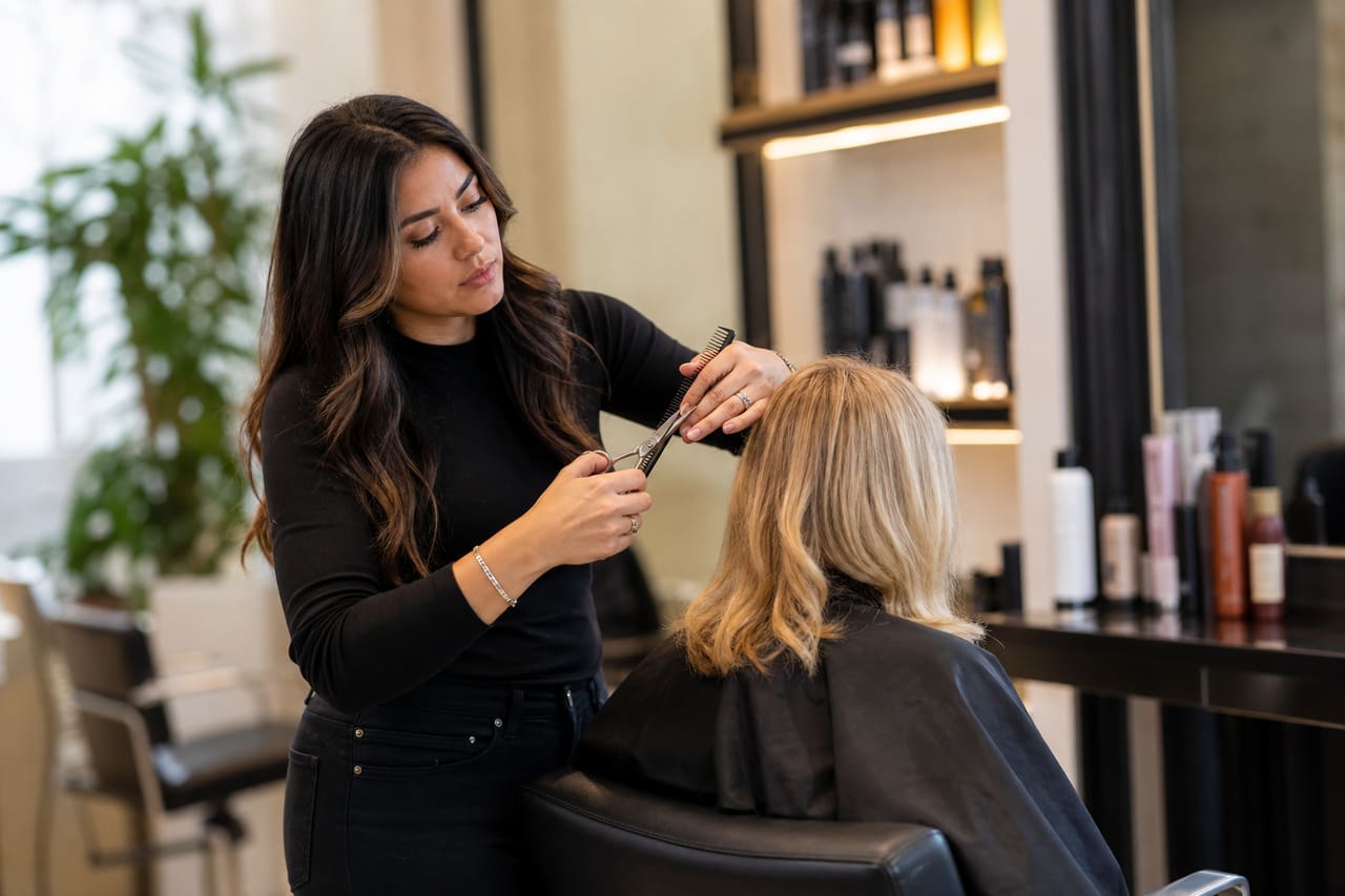 Professional Hairdresser Styling a Client in a Modern Salon