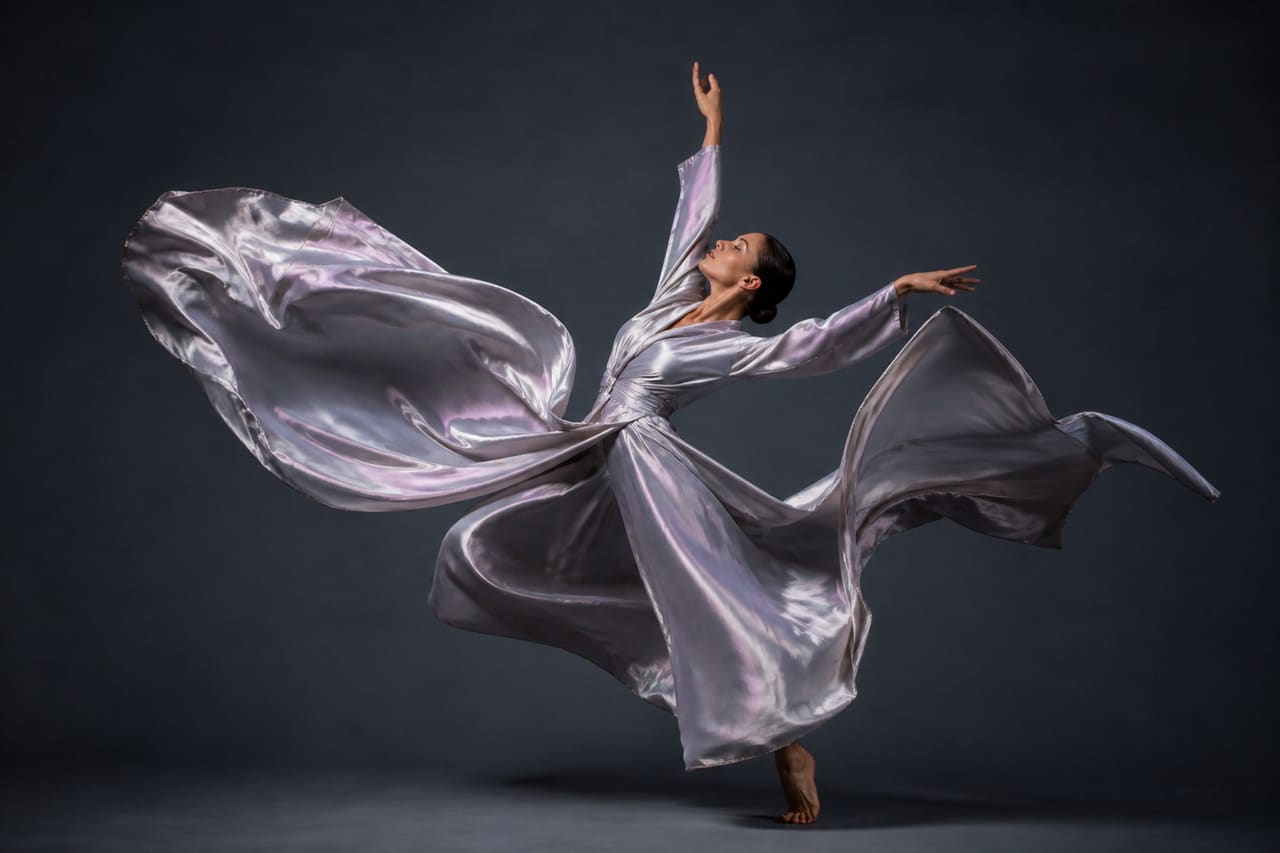 Contemporary Dancer Performing with Flowing Silk Fabric