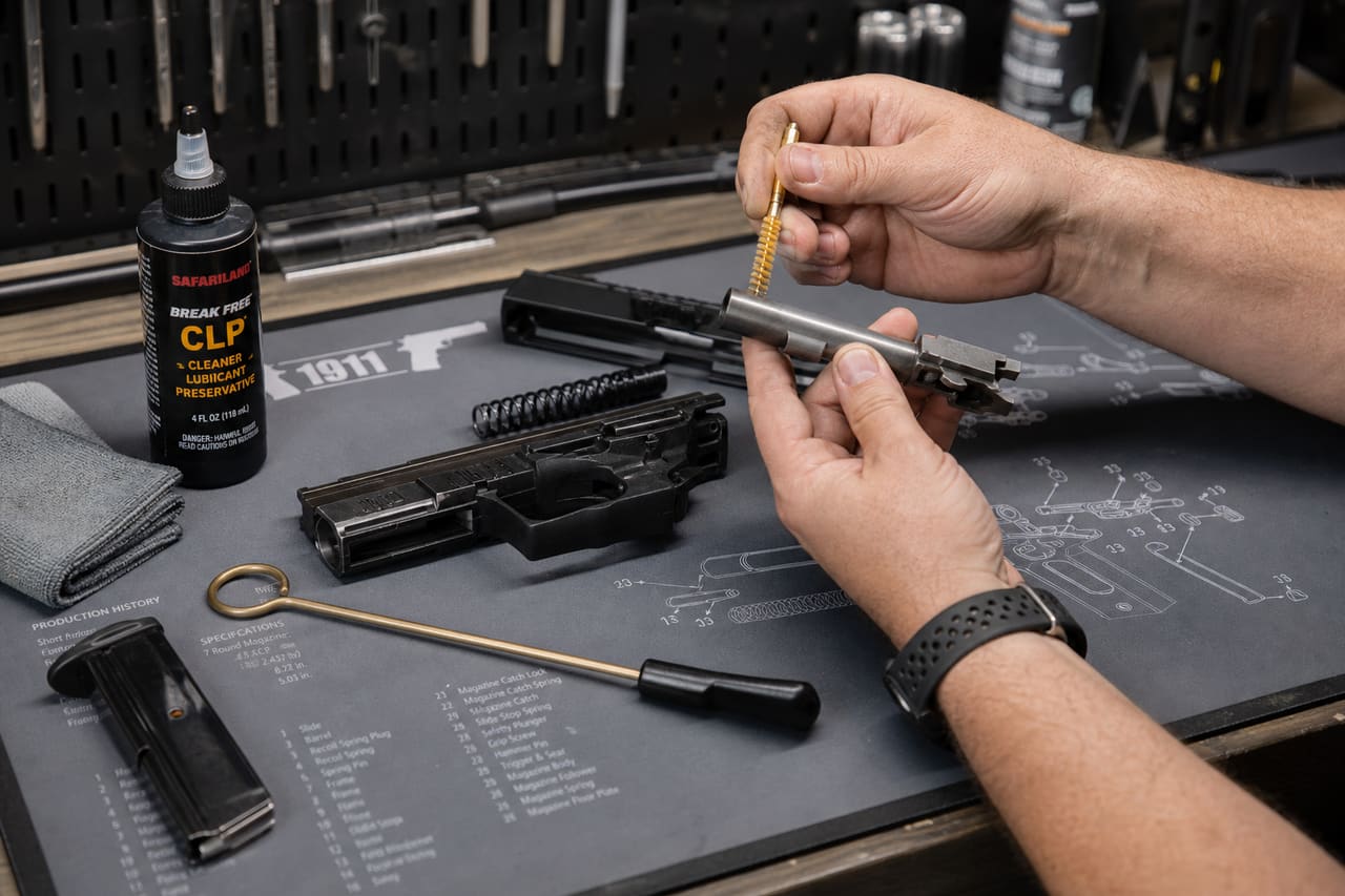 Person Cleaning a Handgun on a Maintenance Mat