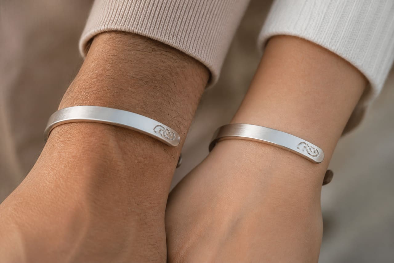 Pair of Minimalist Touch Bracelets on Couple's Wrists