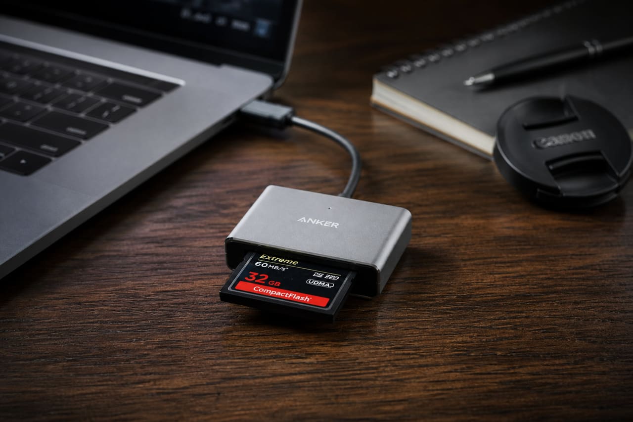 Compactflash Card Reader Connected to Laptop on Wooden Desk