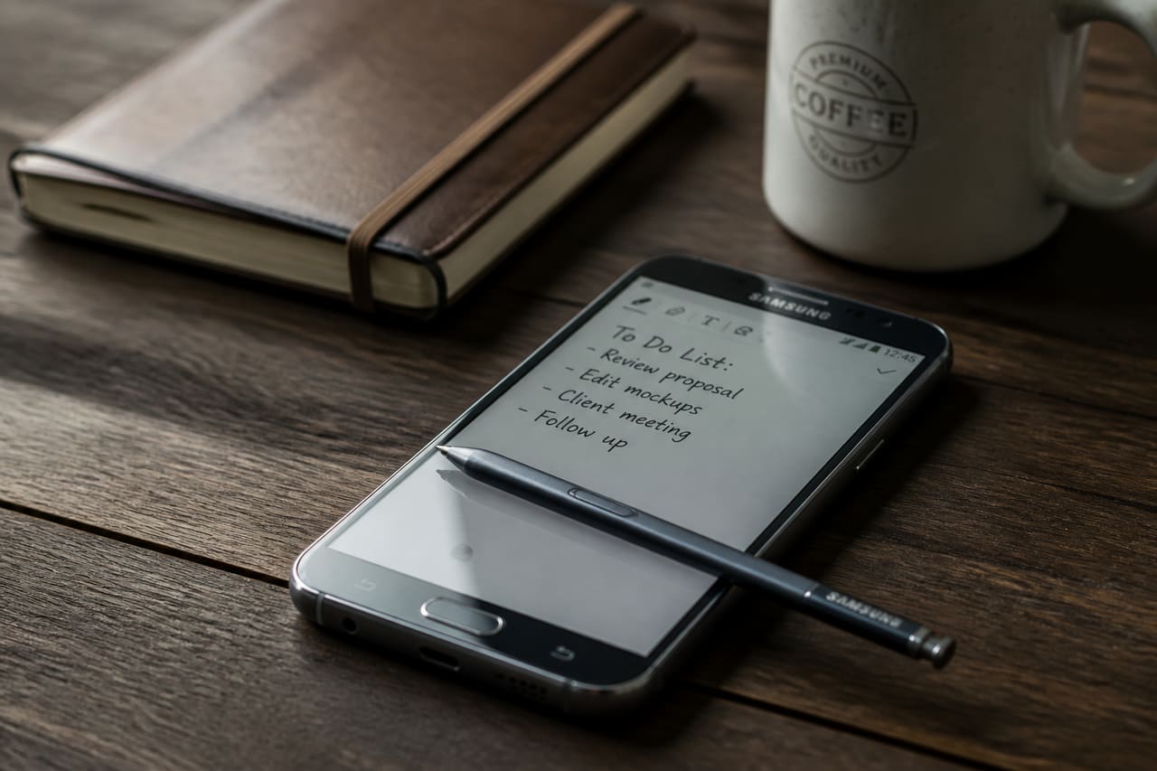 Smartphone with Stylus Pen on a Wooden Desk