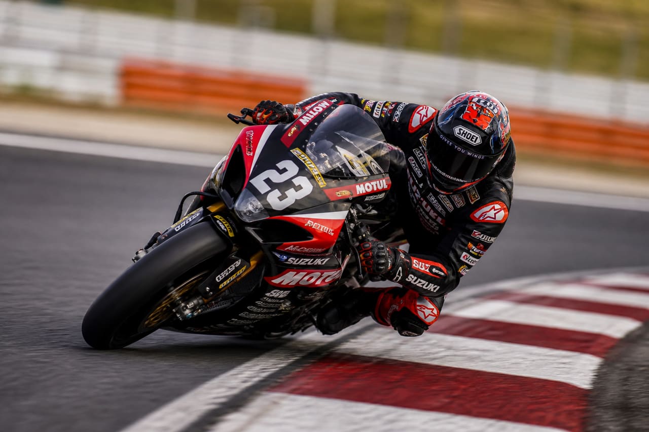 Professional Motorcycle Racer Leaning Into a Curve on an Indian Race Track