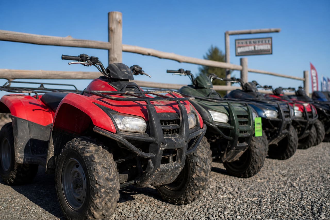 Used Gas Four Wheelers Parked at Rural Dealership