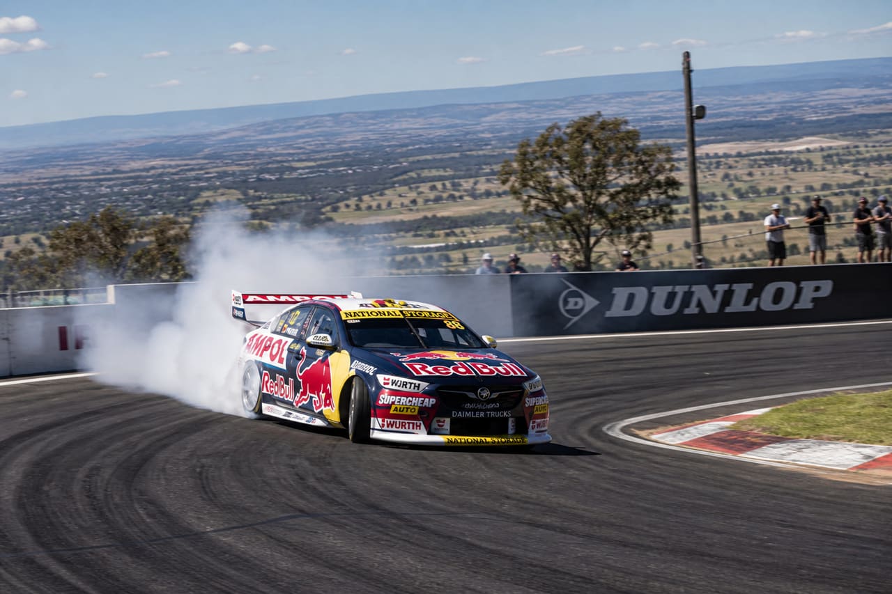 Touring Car Racing Through a Bend at Mount Panorama