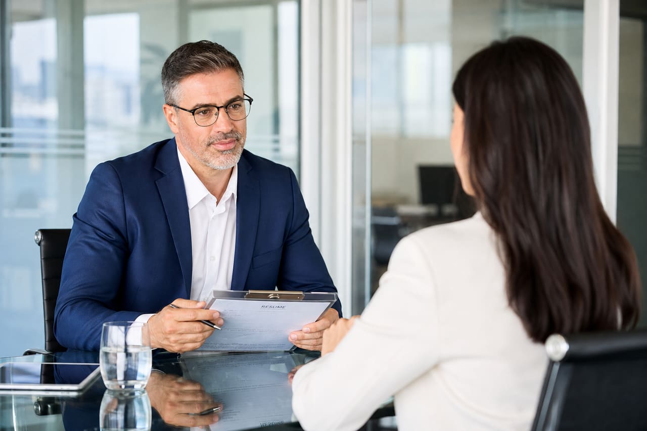 Hiring Manager Interviewing a Candidate in a Modern Insurance Office
