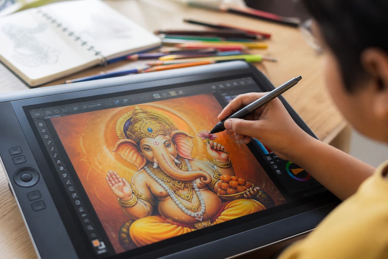 Child Drawing Lord Ganesh on a Digital Tablet