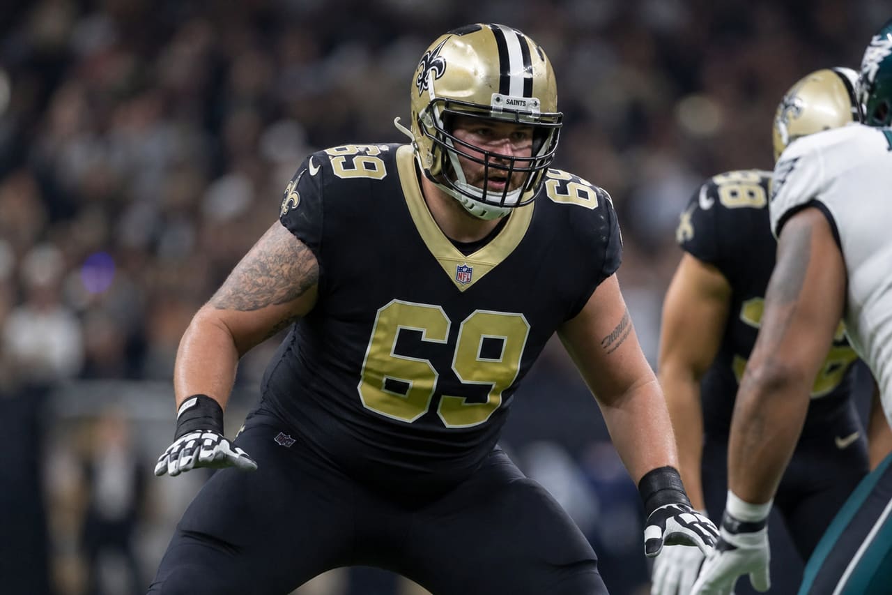 Football Player Wearing Number 69 Jersey on Stadium Field