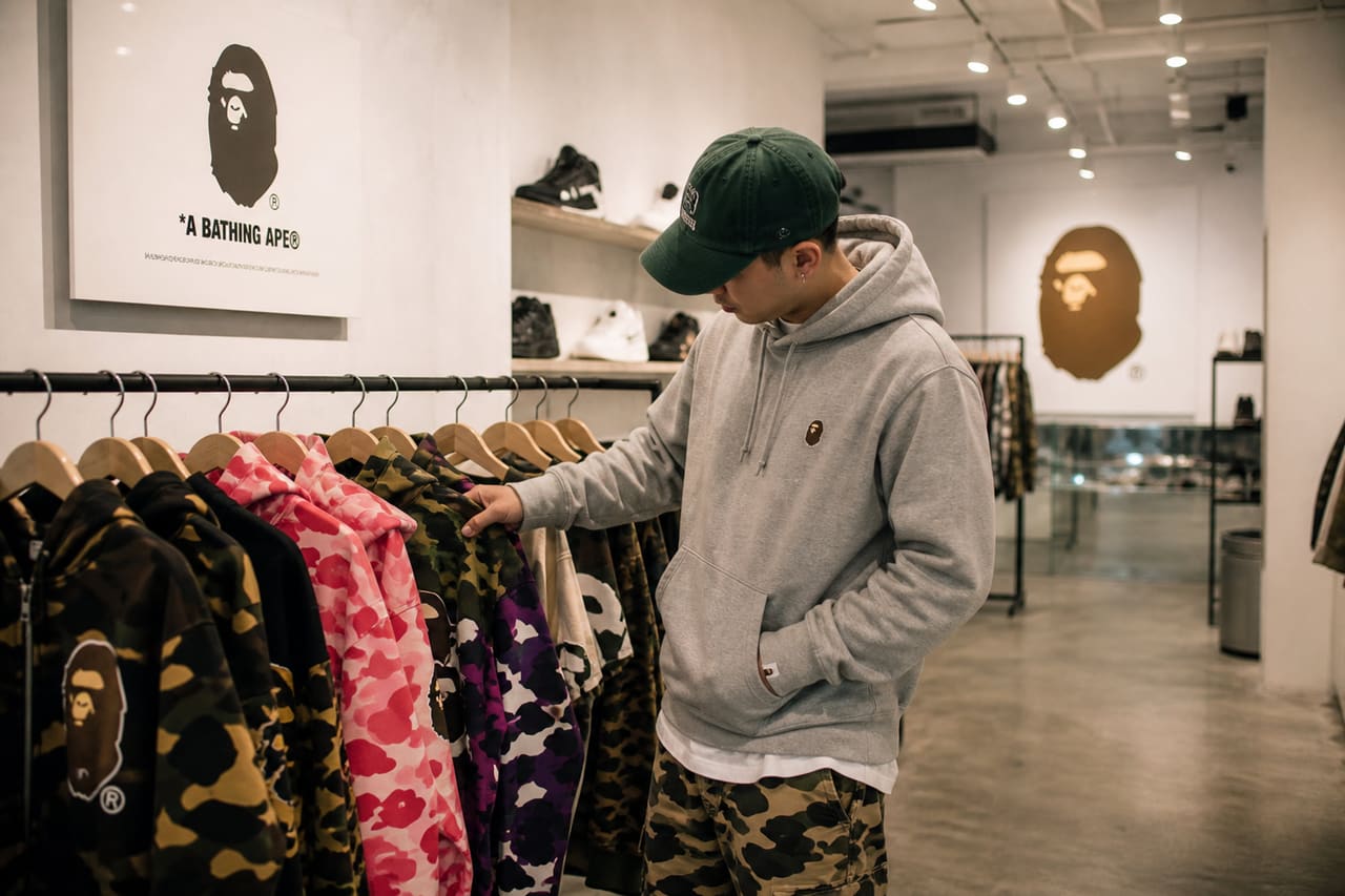 Customer Browsing Streetwear Apparel in a Modern Urban Boutique